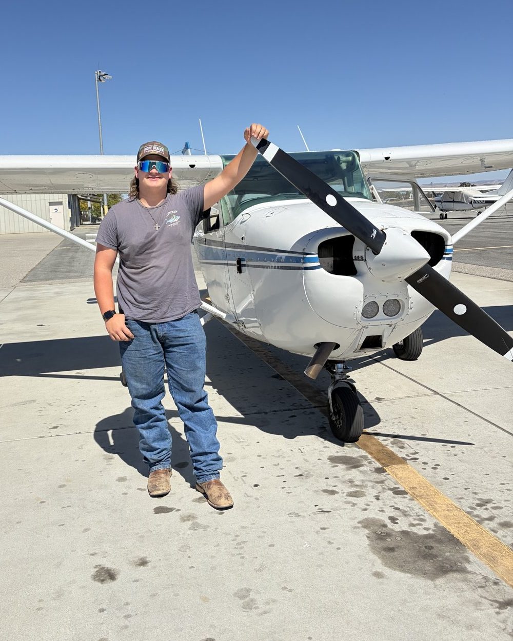 Aaron Bower standing next to a small airplane