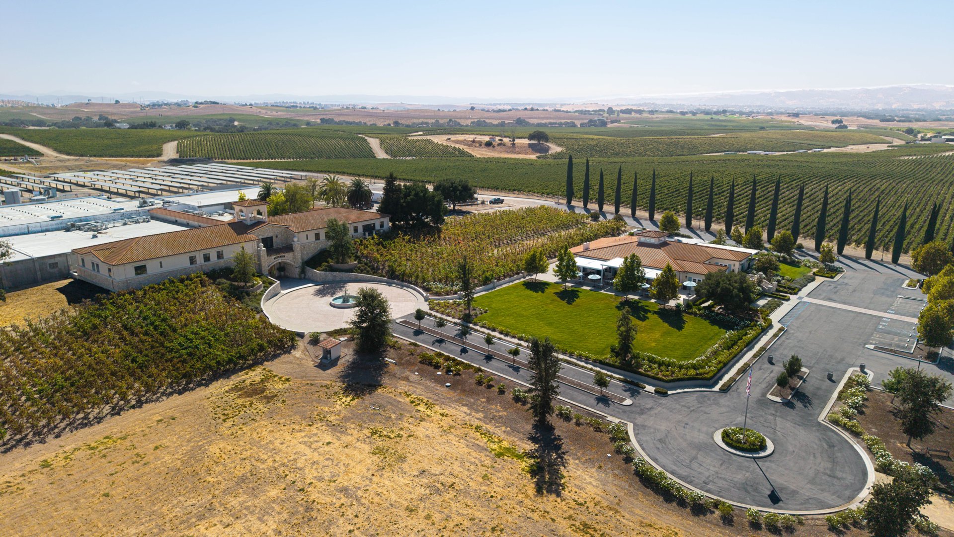 Aerial view of the vineyard property, landscaped grounds, and surrounding fields